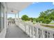 Balcony featuring decorative railings with a view of tree lined grounds at 2428 Columbia Dr # 72, Clearwater, FL 33763
