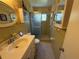 Vintage style bathroom features a walk-in shower, floral wallpaper, tiled flooring, and classic fixtures at 2428 Columbia Dr # 72, Clearwater, FL 33763