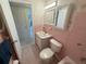 Retro pink bathroom features a tub/shower combo, vanity with sink, and matching pink tile at 2428 Columbia Dr # 72, Clearwater, FL 33763