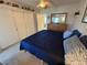 A quaint bedroom with a ceiling fan, closet, and wooden dresser creates a relaxing and functional space at 2428 Columbia Dr # 72, Clearwater, FL 33763