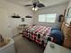 Cozy bedroom featuring a decorative bed frame, a ceiling fan and natural light from the window at 2428 Columbia Dr # 72, Clearwater, FL 33763