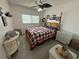 Cozy bedroom featuring a decorative bed frame, a ceiling fan and natural light from the window at 2428 Columbia Dr # 72, Clearwater, FL 33763