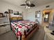 Cozy bedroom featuring a decorative bed frame, a ceiling fan and natural light from the window at 2428 Columbia Dr # 72, Clearwater, FL 33763