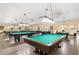 Spacious game room with multiple billiard tables and lighting for friendly competition and entertainment at 2428 Columbia Dr # 72, Clearwater, FL 33763