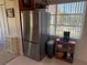 Kitchen featuring stainless steel refrigerator with adjacent windows and cabinets at 2428 Columbia Dr # 72, Clearwater, FL 33763