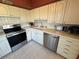 Well-lit kitchen showcases white cabinets, stainless steel appliances, and clean tile flooring at 2428 Columbia Dr # 72, Clearwater, FL 33763