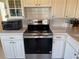 Bright kitchen features white cabinets, countertops and modern stainless steel appliances at 2428 Columbia Dr # 72, Clearwater, FL 33763