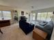 Bright living room featuring plush seating, large windows, and a view from the doorway to the outside balcony at 2428 Columbia Dr # 72, Clearwater, FL 33763