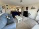 Bright living room featuring neutral carpet, cozy furniture, and a view of the dining area at 2428 Columbia Dr # 72, Clearwater, FL 33763
