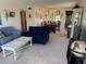 Bright living room featuring neutral carpet, cozy furniture, and a view of the dining area at 2428 Columbia Dr # 72, Clearwater, FL 33763