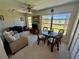 Bright and airy sunroom with a sofa and rattan table and chairs at 2428 Columbia Dr # 72, Clearwater, FL 33763