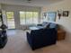 Bright living room featuring neutral carpet, cozy furniture, and access to the balcony at 2428 Columbia Dr # 72, Clearwater, FL 33763