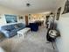 Bright living room featuring neutral carpet, cozy furniture, and a beach-themed painting at 2428 Columbia Dr # 72, Clearwater, FL 33763