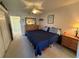 Comfortable main bedroom with a ceiling fan and neutral-toned decor and hardwood dresser at 2428 Columbia Dr # 72, Clearwater, FL 33763