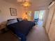 Comfortable main bedroom with a ceiling fan and a bright, light-filled sunroom at 2428 Columbia Dr # 72, Clearwater, FL 33763