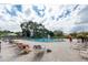Outdoor pool area with ample seating, lush landscaping and mature trees at 2428 Columbia Dr # 72, Clearwater, FL 33763