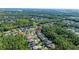 Expansive aerial view of a residential neighborhood surrounded by lush greenery and mature trees at 27524 Pine Point Dr, Wesley Chapel, FL 33544