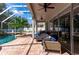 Covered outdoor patio area features a screened-in pool with waterfall at 27524 Pine Point Dr, Wesley Chapel, FL 33544