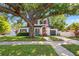 Beautiful two-story home with mature trees, manicured lawn, and a welcoming red front door at 2833 7Th N St, St Petersburg, FL 33704