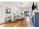 Inviting living room with hardwood floors, gray sectional, and cozy fireplace in a well-lit space at 2833 7Th N St, St Petersburg, FL 33704