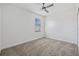 Bright bedroom with carpet flooring, a ceiling fan, and a window at 310 Cockle Shell Loop, Apollo Beach, FL 33572