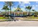 Community clubhouse featuring classic architectural design, lush landscaping, and pedestrian walkway in Harbour Isles at 310 Cockle Shell Loop, Apollo Beach, FL 33572