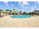 Outdoor community pool offering a refreshing escape with bright yellow buildings and ample seating for residents at 310 Cockle Shell Loop, Apollo Beach, FL 33572