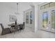 Open concept dining room with chandelier, table set, and large windows overlooking the yard at 310 Cockle Shell Loop, Apollo Beach, FL 33572