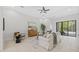 Bright living room with tile floors, light walls, and access to the pool area at 310 Cockle Shell Loop, Apollo Beach, FL 33572