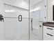 Stylish bathroom with a glass shower door, marble tile, and sleek black fixtures at 3205 W De Leon St # B, Tampa, FL 33609