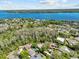 An aerial view shows the home with lake views and mature trees providing privacy at 3267 Westcott Ct, Palm Harbor, FL 34684