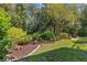 Landscaped backyard with a freshly mulched area and lush lawn, enhancing the outdoor living space at 3267 Westcott Ct, Palm Harbor, FL 34684