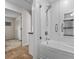 Modern bathroom with a glass-enclosed tub and shower, plus built in storage shelves at 3267 Westcott Ct, Palm Harbor, FL 34684