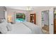 Bright bedroom with ceiling fan, bookshelf, and sliding glass door leading to screened-in pool at 3267 Westcott Ct, Palm Harbor, FL 34684