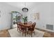 Bright dining room with a wooden table, classic chairs, and a decorative light fixture at 3267 Westcott Ct, Palm Harbor, FL 34684