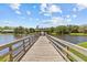 Scenic lake view from a wooden dock, offering tranquil waterfront access and community gazebo at 3267 Westcott Ct, Palm Harbor, FL 34684