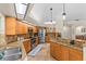 Well-lit kitchen with stainless steel appliances, wood cabinets, granite countertops, and breakfast bar at 3267 Westcott Ct, Palm Harbor, FL 34684