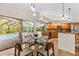 Bright kitchen area featuring a breakfast nook and large sliding glass doors leading to the screened pool area at 3267 Westcott Ct, Palm Harbor, FL 34684