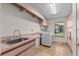 Functional laundry room with sink, countertop, and modern washer and dryer at 3267 Westcott Ct, Palm Harbor, FL 34684