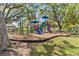 Community playground with colorful play structures and mature trees, perfect for Gathering fun at 3267 Westcott Ct, Palm Harbor, FL 34684