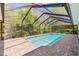 The screened-in pool features a spa and brick patio area for relaxing and entertaining at 3267 Westcott Ct, Palm Harbor, FL 34684