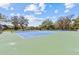 Well-maintained tennis courts providing a recreational amenity in the community with lush trees surrounding at 3267 Westcott Ct, Palm Harbor, FL 34684