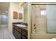 This bathroom features a vanity and a shower-tub combo with sliding glass doors at 3418 Cullendale Dr, Tampa, FL 33618