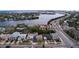 Aerial view of waterfront community with boating access and scenic bridge in the background at 3503 Casablanca Ave, St Pete Beach, FL 33706