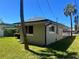 Charming home exterior featuring a well-maintained lawn and palm trees at 3503 Casablanca Ave, St Pete Beach, FL 33706