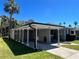 Exterior view of home featuring a carport and well-maintained landscaping at 3503 Casablanca Ave, St Pete Beach, FL 33706