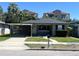 Single-story home with a carport, front yard, and traditional design, showcasing its curb appeal at 3503 Casablanca Ave, St Pete Beach, FL 33706