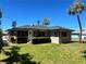 Inviting home with a lush green lawn and tropical palm trees at 3503 Casablanca Ave, St Pete Beach, FL 33706