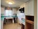 Kitchen with tiled countertops, white cabinets, and appliances at 3503 Casablanca Ave, St Pete Beach, FL 33706
