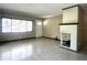 Bright living room featuring a decorative fireplace and lots of light from a large window at 3503 Casablanca Ave, St Pete Beach, FL 33706